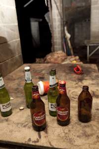 Beer bottles with pile of guts in background - Wally's slaughter room - Captured at Wally's Piggery, Jeir NSW Australia.
