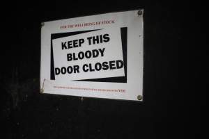 Sign: 'Keep this bloody door closed' - Australian pig farming - Captured at Finniss Park Piggery, Mannum SA Australia.