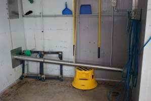 Pipe leading from macerator room (right) to dumpster outside (left) - Carries out remains of macerated chicks - Captured at SBA Hatchery, Bagshot VIC Australia.